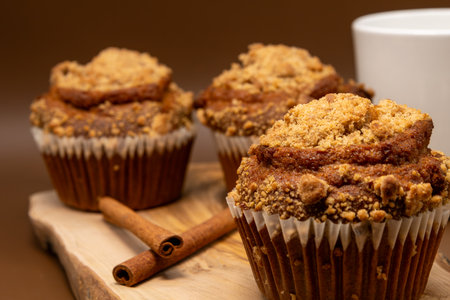 Homemade pumpkin muffins with cinnamon on a wooden board, selective focusの写真素材