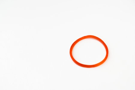 Red rubber band isolated on white backgroundの写真素材