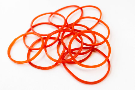Group of red rubber bands isolated on white backgroundの写真素材