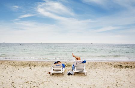 two people relaxing on the beachの写真素材