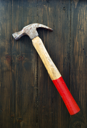 Old steel hammer on wooden backgroundの写真素材