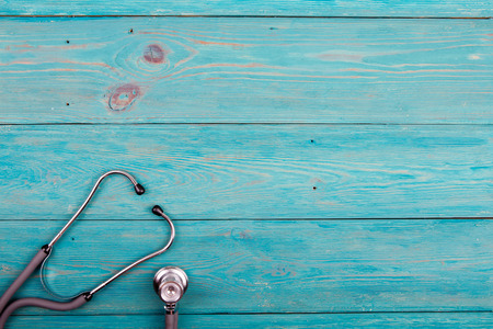 Medicine stethoscope on the blue wooden deskの写真素材