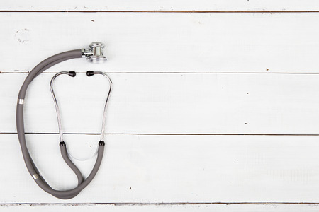 Medicine stethoscope on the white wooden deskの写真素材