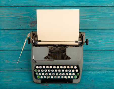 Vintage typewriter on the blue wooden deskの写真素材