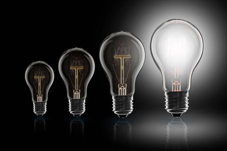 Idea and  leadership concept -  incandescent light bulb on the black background