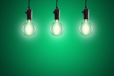 Idea concept -  incandescent bulbs on green background