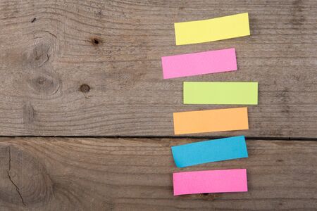Colorful sticky notes on the wooden boardの写真素材