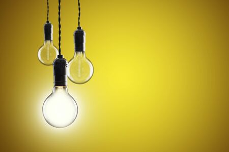 Idea and leadership concept Vintage incandescent Edison type bulbs on color wallの写真素材