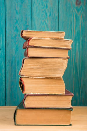 stack of books on the desk over wooden backgroundの写真素材