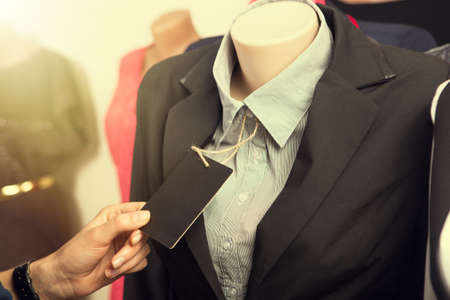 Clothes hanging on the rack in the fashion storeの写真素材