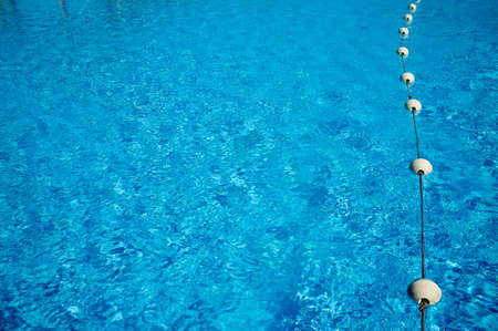 Blue water in the swimming pool, safety buoys