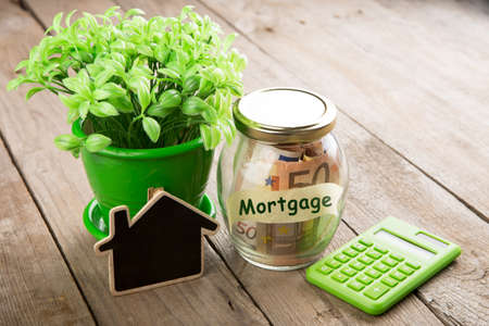 Real estate finance concept - money glass with Mortgageの写真素材
