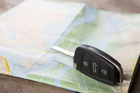 Car rental concept - car key on the road mapの写真素材