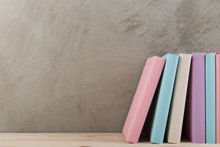 Education and reading concept - group of colorful books on the wooden tableの写真素材
