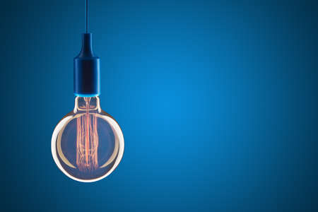 Idea and leadership concept - Vintage bulbs on the blue background