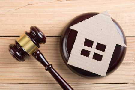 Real estate sale auction concept - gavel and house modelの写真素材