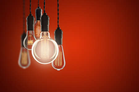 Idea and leadership concept Vintage bulbs on color wall background, copy space for text