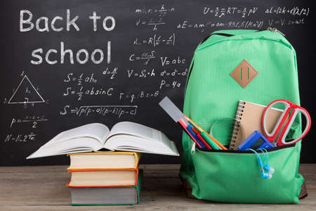 Education concept - school backpack with books and other supplies
