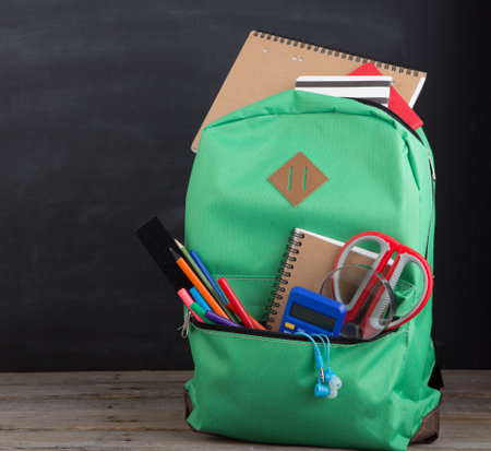 Education concept - school backpack with books and other suppliesの写真素材
