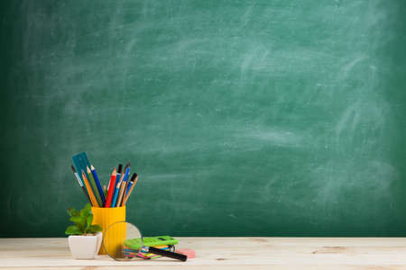 Education concept - school supplies on the desk in the auditoriumの写真素材