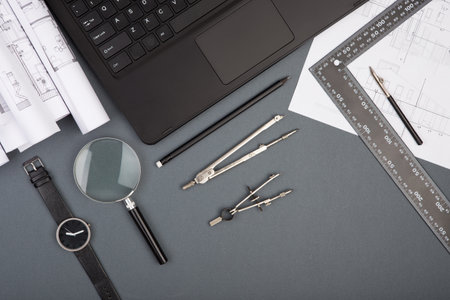 Workplace of architect - construction drawings, laptop, scale model of a house and toolsの写真素材