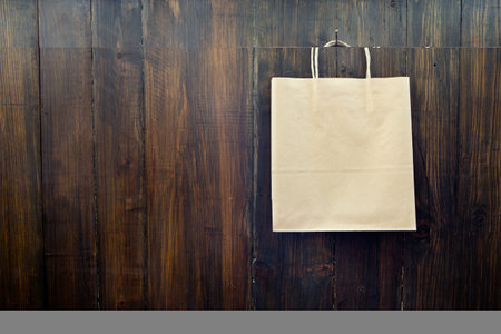 Paper pocket hanging on the wooden wallの写真素材