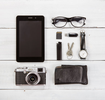tourism concept - set of camera, tablet PC and other travel stuff on wooden tableの写真素材