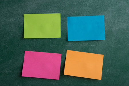 Colorful sticky notes on the blank blackboardの写真素材