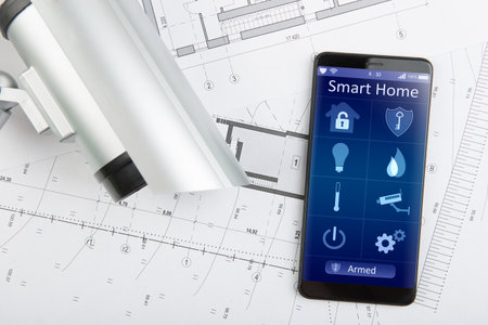Home security concept - smartphone with smart home app and surveillance cctv camera on the desk