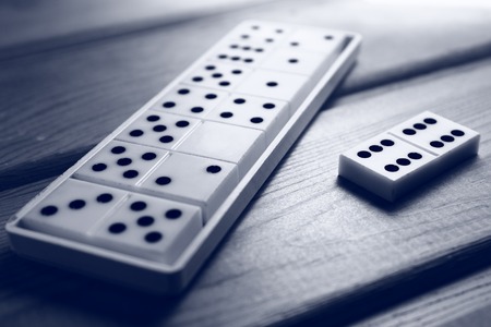 Playing dominoes close-up on a wooden backgroundの写真素材