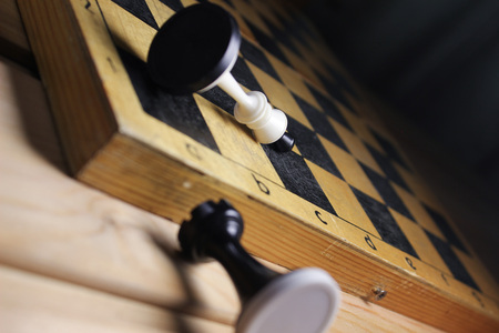 Chess and chess board on wooden background