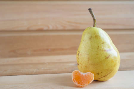 Pear and slice of mandarinの写真素材