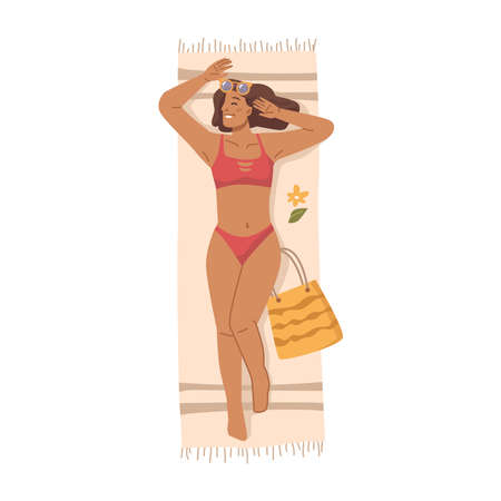 Attractive woman in sunglasses and bikini swimsuit sunbathing on towel at beach, flat cartoon character. Vector top view of lying suntanning girl on mat with vacation bagのイラスト素材