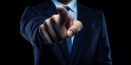 a businessman in a dark blue suit pointing his index fingerの素材