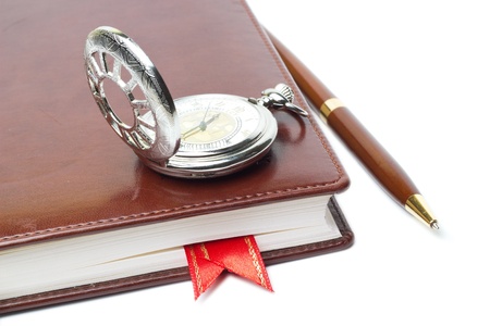 Notebook, pen and clockの写真素材