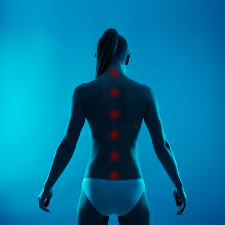 Shirtless woman with healthy back. Spine disease and scoliosis treatment concept.の写真素材
