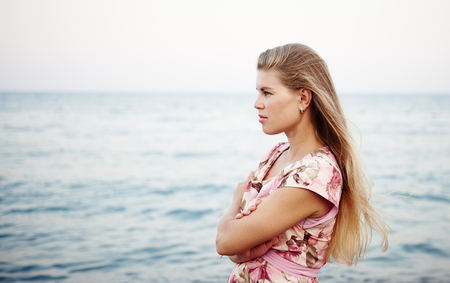 Attractive blond female relaxing on the beach.の写真素材