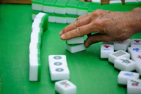 A hand making a move in a Chinese game.の写真素材