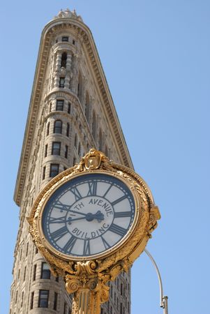 New York, New York, July 2, 2010 - The historic Flatiron Building and 5th Avenue Clock in New York City.のeditorial素材