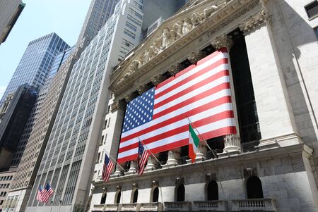 New York, New York, July 12, 2010 - The historic New York Stock Exchange at 11 Wall Street, decorated with a large American flag.のeditorial素材