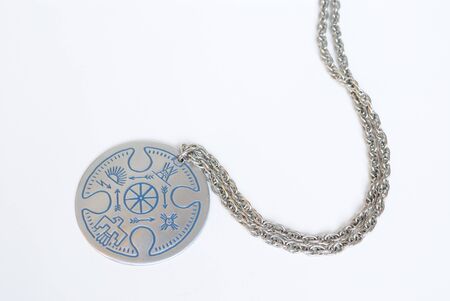A silver necklace with native american designs.の写真素材