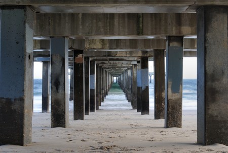 Under a pier on the beach at Coney Island in New York City.の写真素材