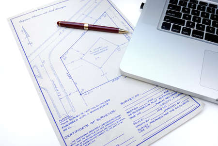 A set of retro looking blue prints with a cutting edge computer.の写真素材