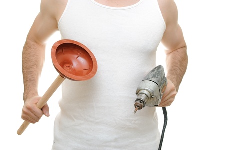carpenter holding a plunger and an electric drillの写真素材