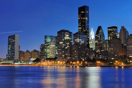 Vertical view of the New York City skyline at midtown Manhattan from across the East River.の写真素材