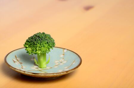 broccoli stainding on a plateの写真素材