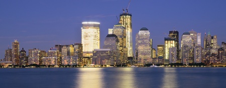 Downtown Manhattan viewed from across the Hudson RIver at night.