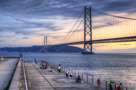 Kobe, Japan - July 10, 2011: Fishermen on the Maiko Park Pier viewing Akashi Kaikyo Bridge in Tarumi-ku, Kobe, Japan.のeditorial素材