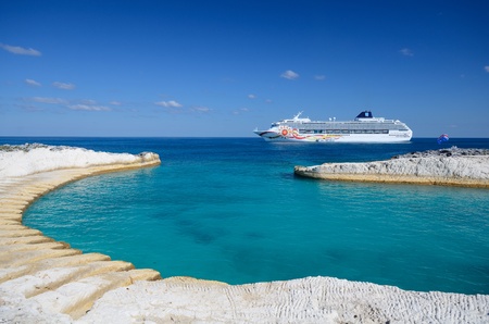Cruise ship off the coast of a sandy caribbean beach