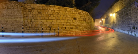Light trails from  vehicles passing through narrow corridors in the Old City of Jerusalem, Israel.の写真素材